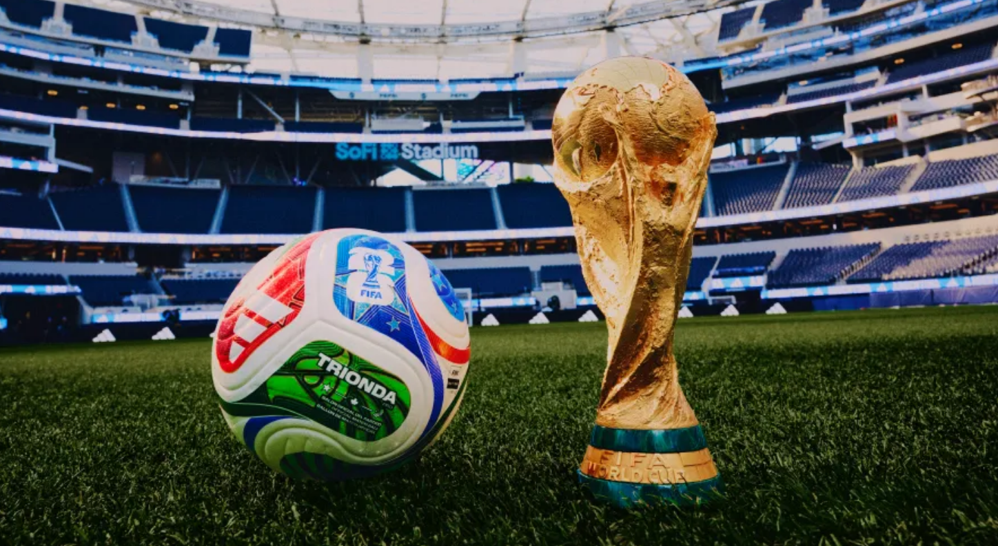 World Cup trophy and match ball inside a stadium
